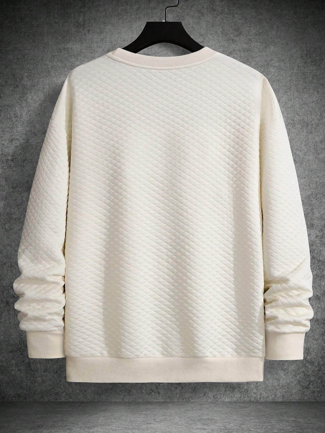 Apricot textured long sleeve sweatshirt with drop shoulders and ribbed cuffs and hem.