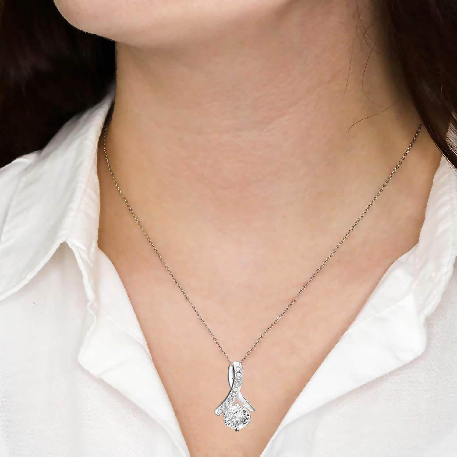 Silver pendant necklace with teardrop-shaped clear crystal on delicate chain.