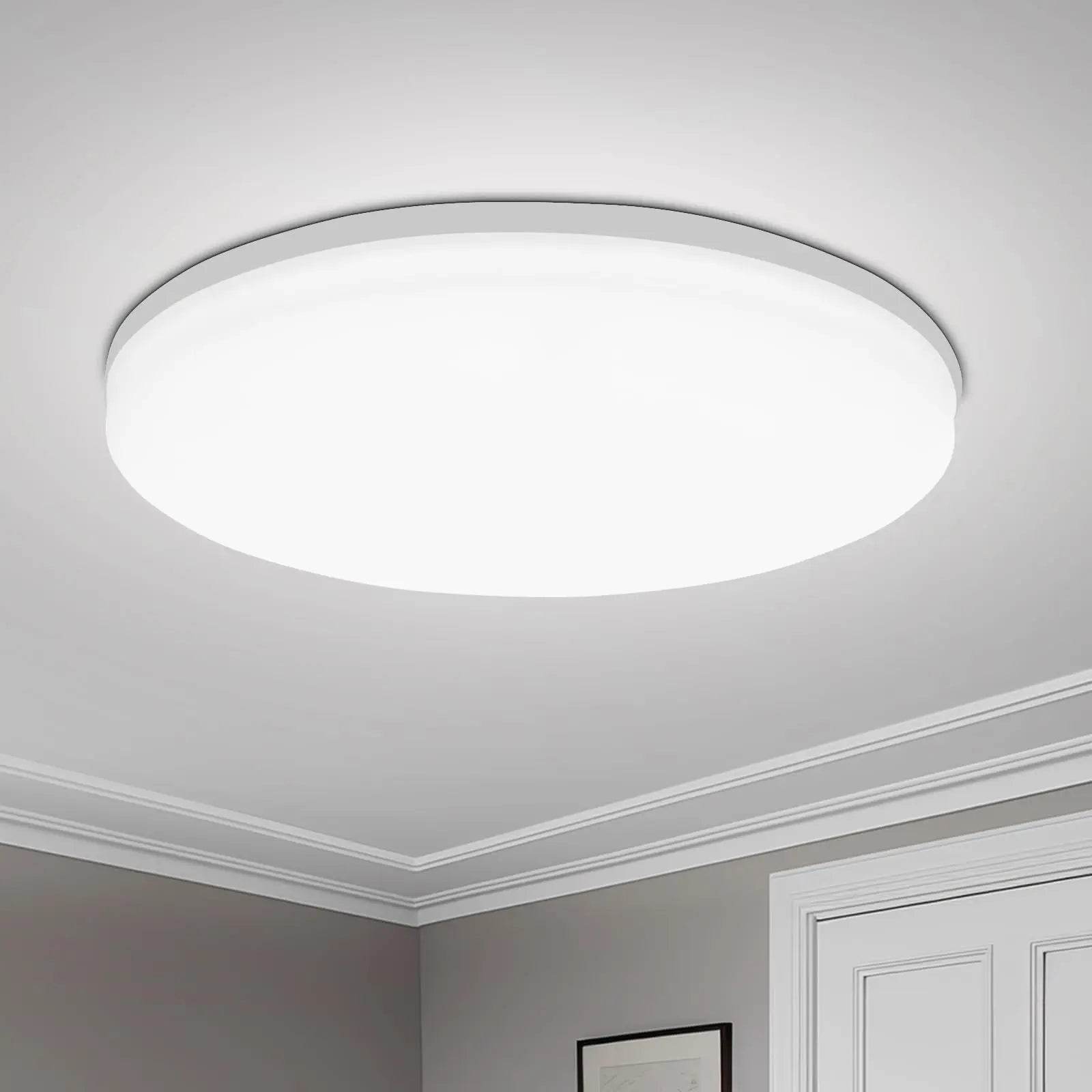 Modern round white LED ceiling light with slim profile, mounted on a white ceiling.