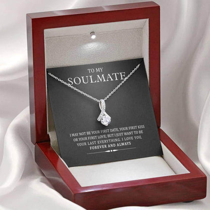 Silver heart-shaped pendant necklace with chain in dark wood display box and black card insert.