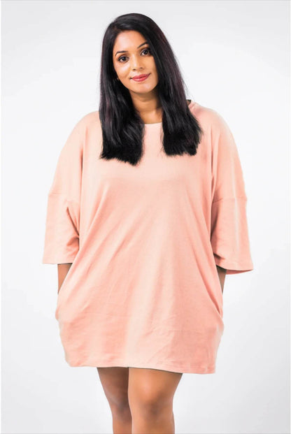Peach relaxed fit oversized T-shirt with elbow-length sleeves on a woman with long black hair.