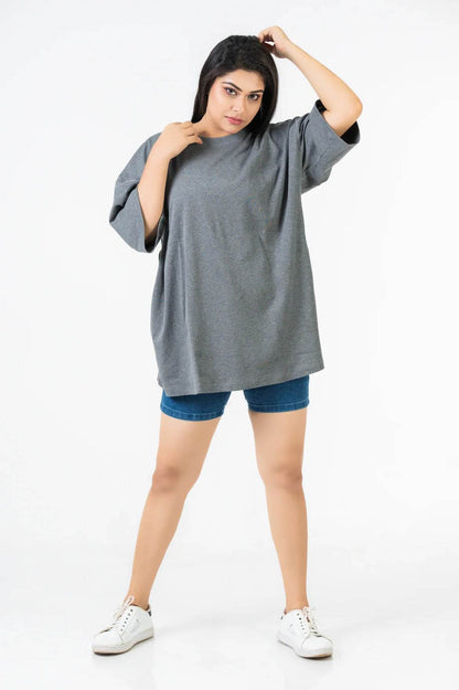 Charcoal heather oversized relaxed fit t-shirt paired with denim shorts and white sneakers on female model.
