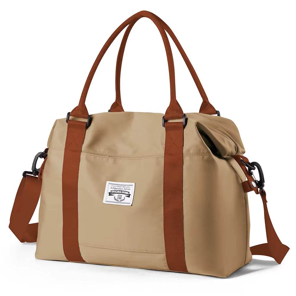 Khaki waterproof duffel bag with brown handles, adjustable shoulder strap, and front patch logo.
