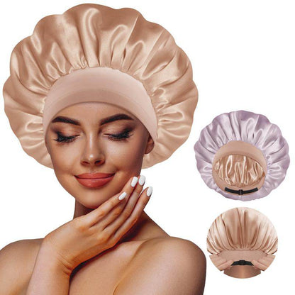 Reversible satin sleeping bonnet in champagne and grey with elastic band, worn by a woman with smooth skin and subtle.