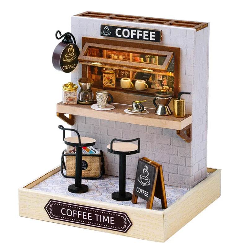 Miniature 3D coffee shop dollhouse with bar counter, stools, coffee cups, and chalkboard sign.