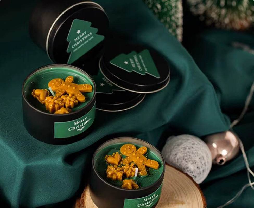 Green vanilla scented soy wax candle in black tin with gingerbread man decoration on top, festive label.