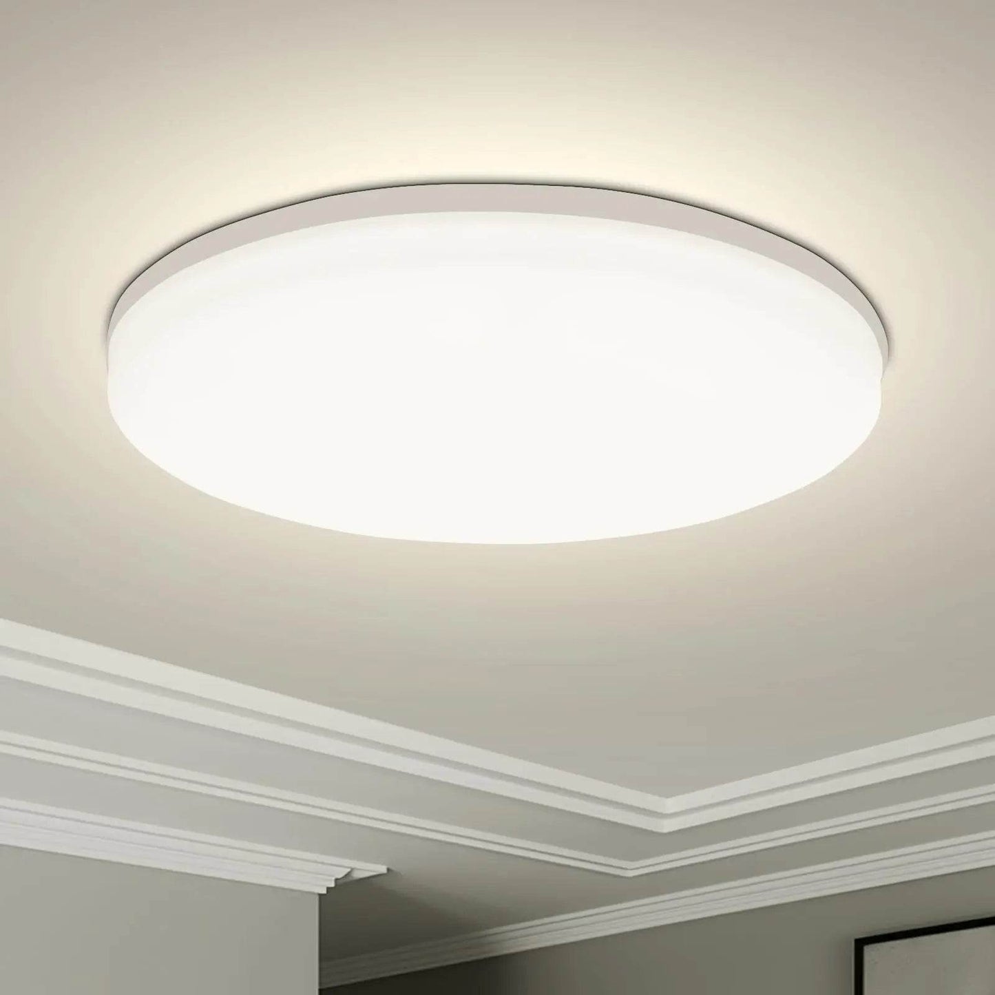 Round white modern LED ceiling light with slim profile mounted on white ceiling.