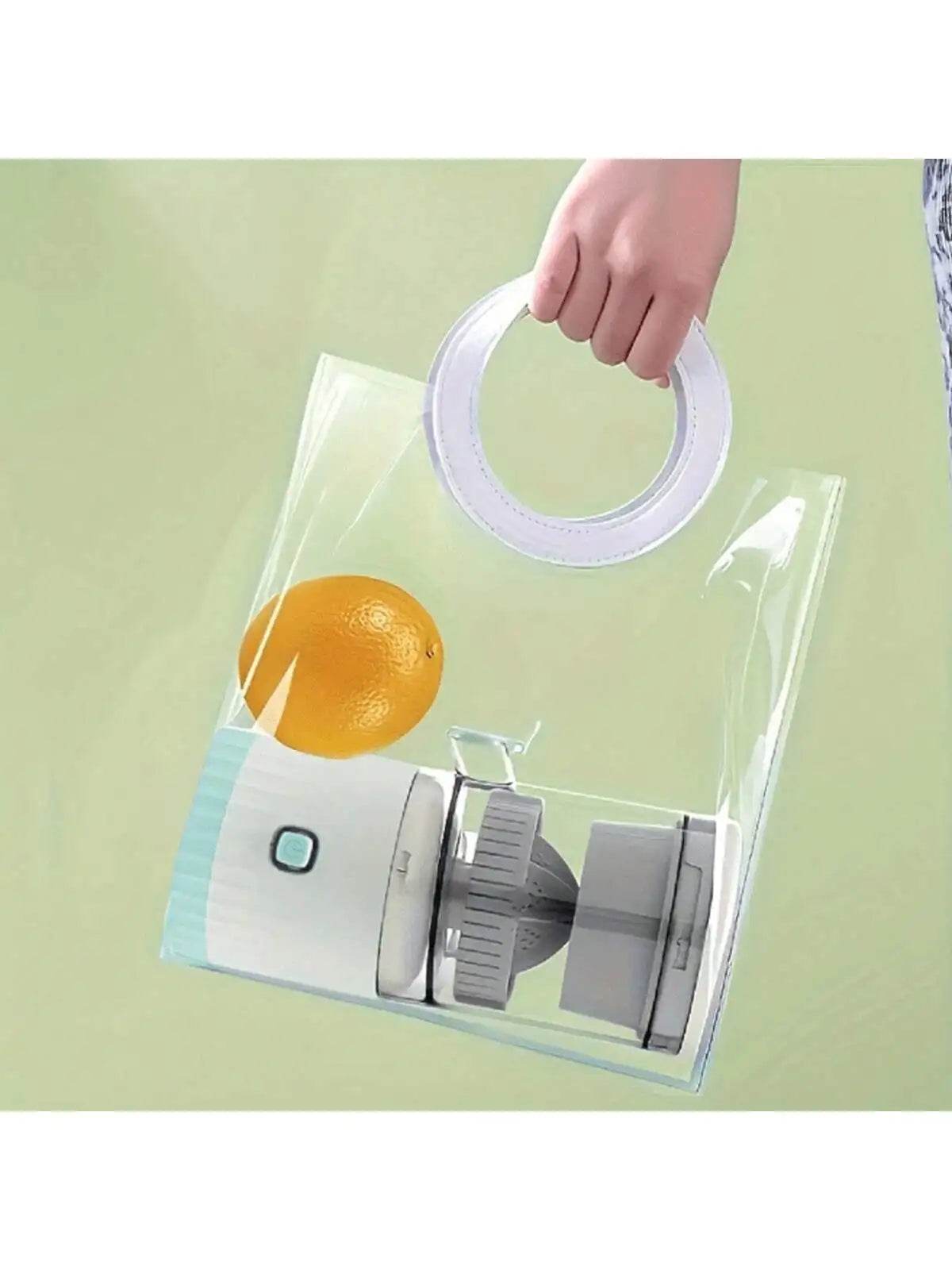 Compact white portable juicer with gray lid and transparent body held by hand with round handle.
