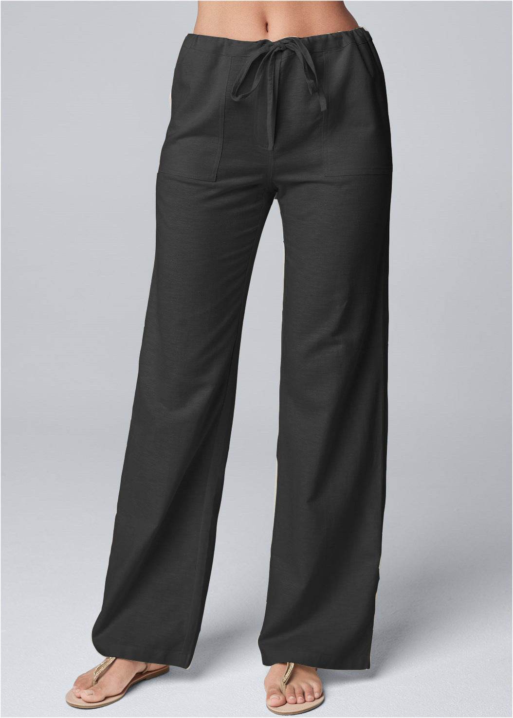 Black loose straight-leg cotton and linen pants with lace-up waistband and pockets.