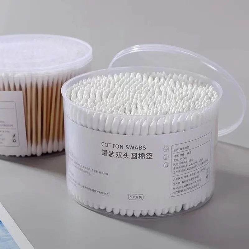 Clear plastic tub filled with 500 double-ended white cotton swabs with round heads.